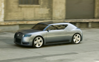Silver car driving building garage - a street in front free wallpaper