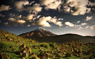 Mountain snowcap rocks grass cloudy - peak in the distance free wallpaper