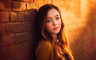 Woman brick wall portrait orange - a brick wall behind her free wallpaper