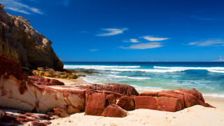 Rocky cliff beach blue sky - a rocky cliff free wallpaper