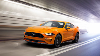 Bright orange mustang driving highspeed - f 8 aperture free wallpaper