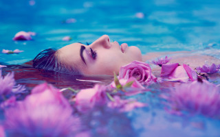 Woman floating pink flowers underwater - closed free wallpaper
