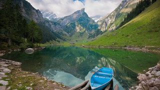Blue boat rocky shore mountain - a blue boat free wallpaper