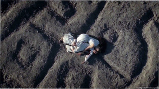 Man laying sand cellphone hands - the sand free wallpaper