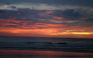 Sunset ocean surfer clouds beach 2 - a sunset over the ocean free wallpaper