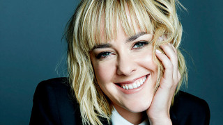 Blonde woman smiling hands on - her cheek free wallpaper
