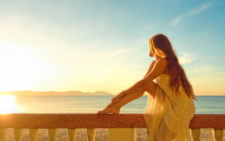 Woman ocean sunset sitting beach - a rail free wallpaper