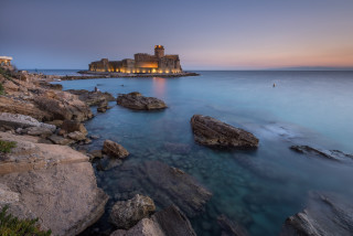 Castle rock shore dusk lighthouse - a lighthouse in the distance free wallpaper