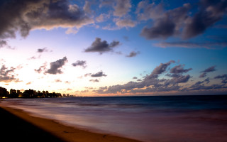 Beach sunset clouds city horizon - a city in the distance free wallpaper