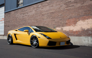Yellow sports car brick building - rim free wallpaper