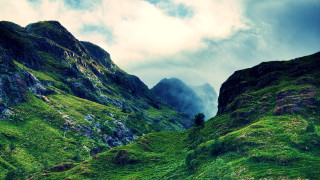 Mountain grassy slope sheep clouds - a few sheep free wallpaper