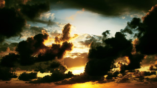 Sunset clouds plane water boat - a body of water below free wallpaper