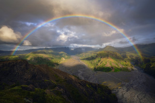 Rainbow mountain river valley horizon - over a mountain range in the distance free wallpaper