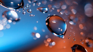 Water droplets blue orange reflection - a close up of water droplets free wallpaper