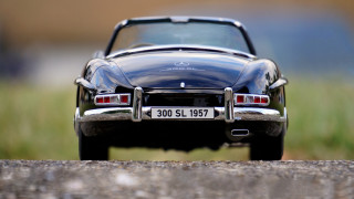 Black car road grass building 2 - the side of a road next free wallpaper