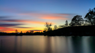 Sunset lake trees hill clouds - a sunset over a lake free wallpaper