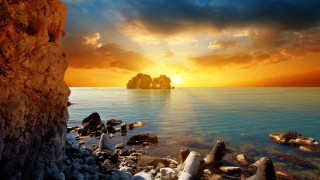 Sunset water rocks formation autumn 2 - a sunset over a body of water free wallpaper