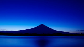Mountain night blue sky ocean - a body of water below free wallpaper