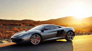 Grey sports car mountain sunset 2 - a road near a mountain range free wallpaper