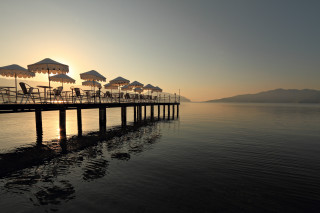 Pier umbrellas chairs sunset bridge - constantine andreou free wallpaper