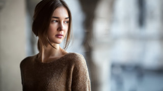 Woman brown sweater serious portrait - her face and shoulder free wallpaper