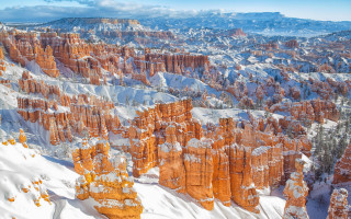 Snowy mountain rocks clouds city - kodachrome free wallpaper
