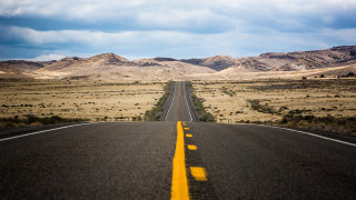 Deserted road mountains cinematic beach - a yellow line free wallpaper