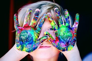 Young girl painted hands eyes - a childs free wallpaper
