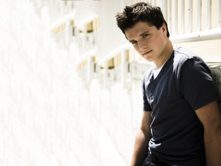 Young man leaning wall serious - his hip free wallpaper