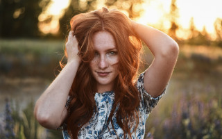 Redhaired woman flowerfield sunset portrait - a picture in a field of flowers free wallpaper