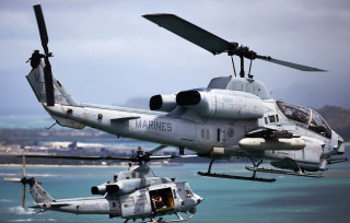 Military helicopters over ocean city - over a body of water free wallpaper