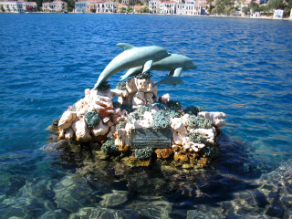 Dolphin statue rock water beach - the water near a beach free wallpaper