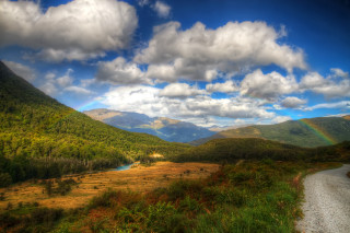 Valley rainbow river mountains beach - a scenic view of a valley free wallpaper