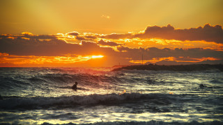 Surfing sunset ocean wave beach - a person riding free wallpaper