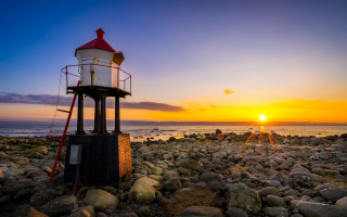 Lighthouse rocky beach sunset ocean 2 - the background and the ocean in the foreground free wallpaper