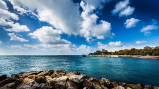 Cloudy sky dock rocks water - a few cloud free wallpaper