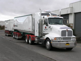 Semi truck parked warehouse cloudy - a warehouse free wallpaper