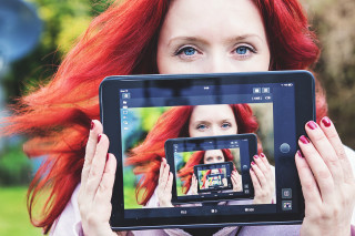 Red hair woman tablet camera - a tablet free wallpaper