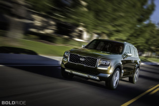 Green suv driving street lush - a street next free wallpaper