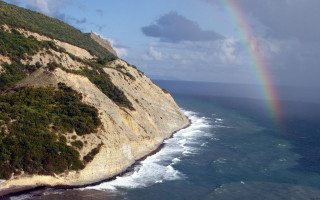 Rainbow ocean cliff boat mountain - a rainbow in the sky free wallpaper