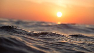 Sunset ocean waves boat cloudy - the foreground and a boat in the distance free wallpaper