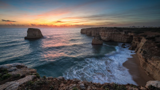 Sunset ocean cliff water beach - a sunset over the ocean free wallpaper