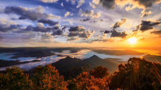 Sunset mountain range clouds trees 4 - a sunset over a mountain range free wallpaper