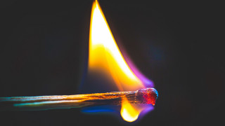 Matchstick yellow flame black background - tip free wallpaper