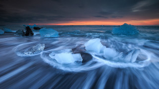 Icebergs sunset cloudy sky water - a group of icebergs free wallpaper