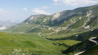 Mountain valley winding road nature 2 - road in the middle of it free wallpaper