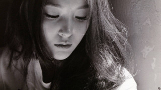 Woman long hair looking down - her phone screen free wallpaper