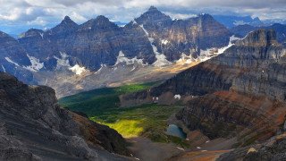 Mountain range valley snow capped 4 - a lake in the foreground free wallpaper