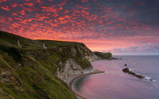 Sunset beach cliff water red - a cliff and a body of water free wallpaper