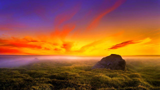 Sunset grassy field rock red - a rock in the foreground free wallpaper